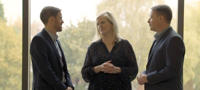 Three people from Lovell Midland and whg discussing our property development partnership. 