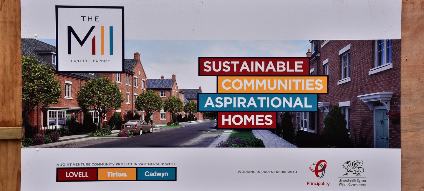 Video thumbnail of a row of houses. The video explains how Lovell regenerated an old paper mill into a new thriving community.